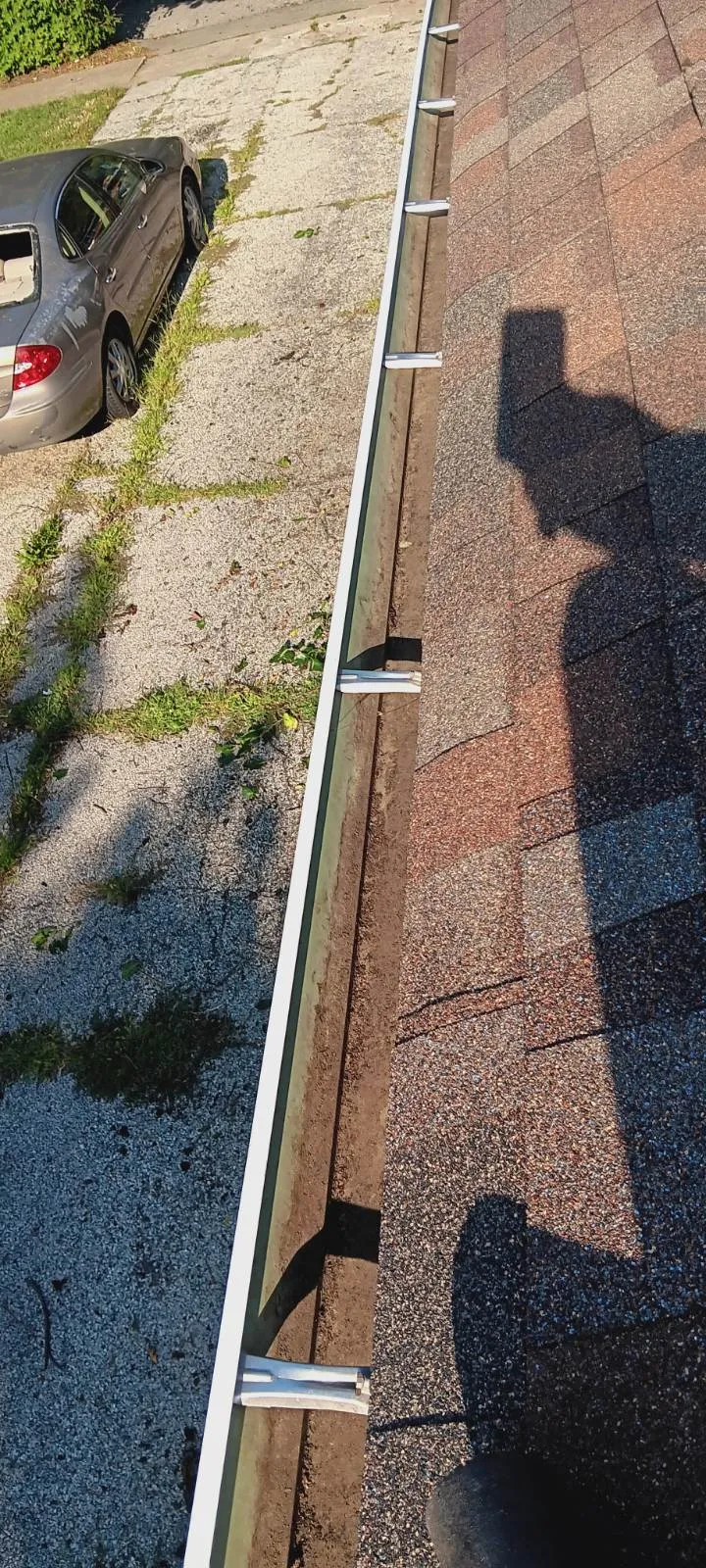 Single-story gutters cleared and draining freely after cleaning